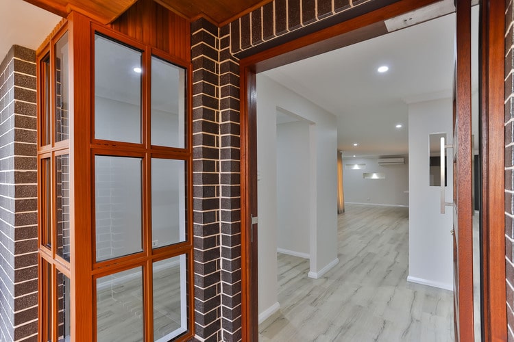 Grey brick and timber entrance area