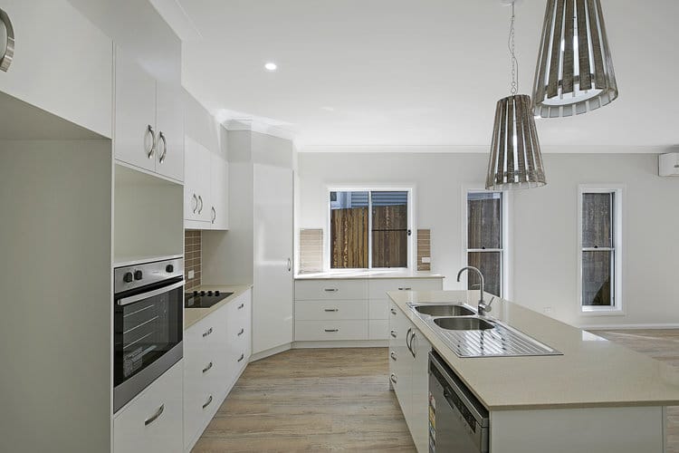 White and beige kitchen with large feature lights