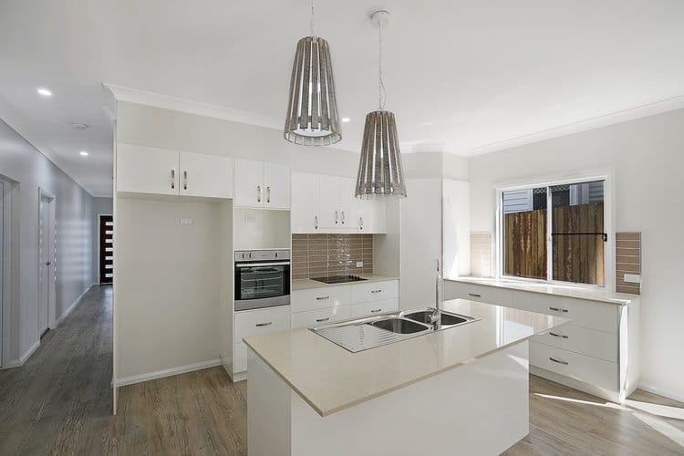 White and beige kitchen opening onto hallway