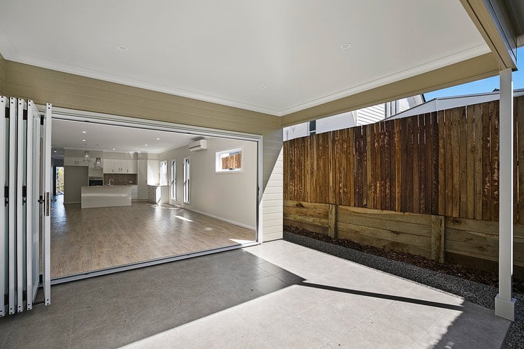 Patio opening onto large dining and kitchen