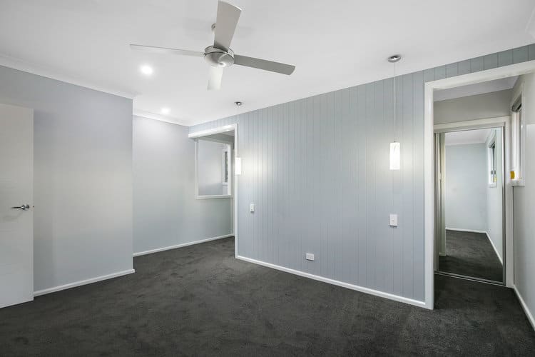 Grey feature wall in master bedroom with walk in robe