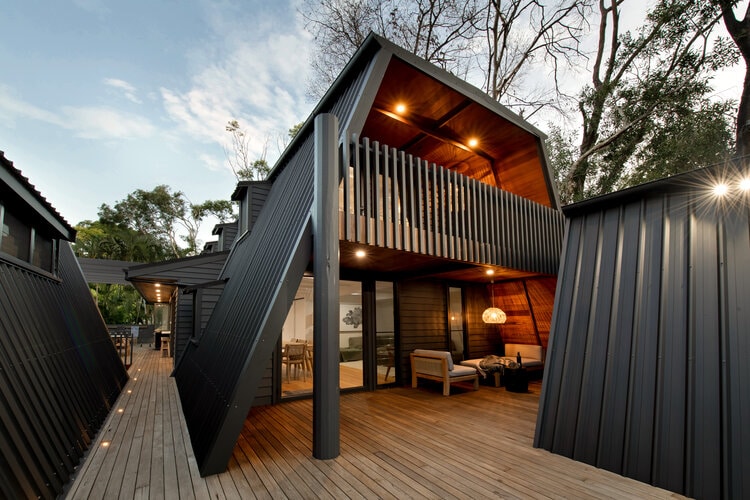 Grey A frame house with timber patio