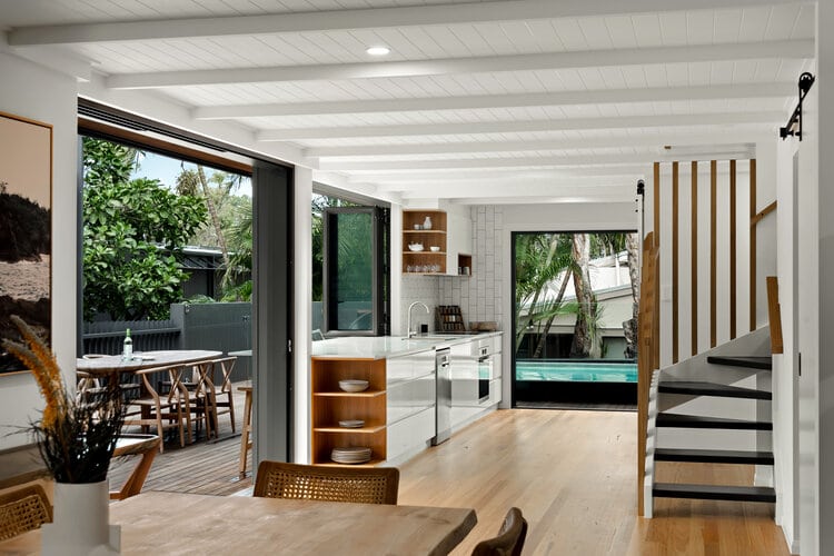 Indoor kitchen area overlooking patio and pool