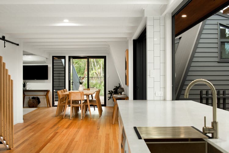 White kitchen with timber floors and dining area