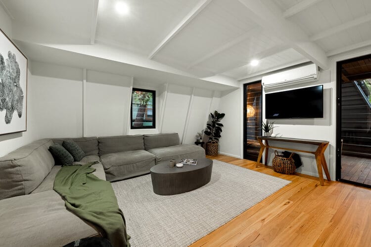 Lounge area with grey sofa and timber floors