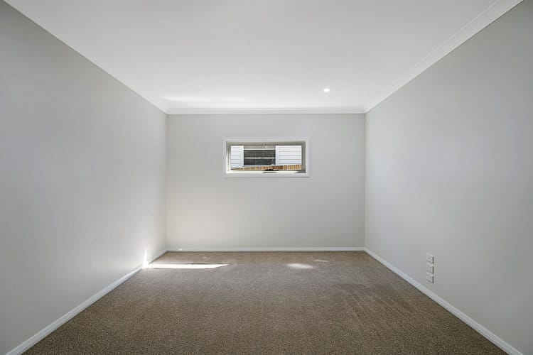 Empty white bedroom with small building