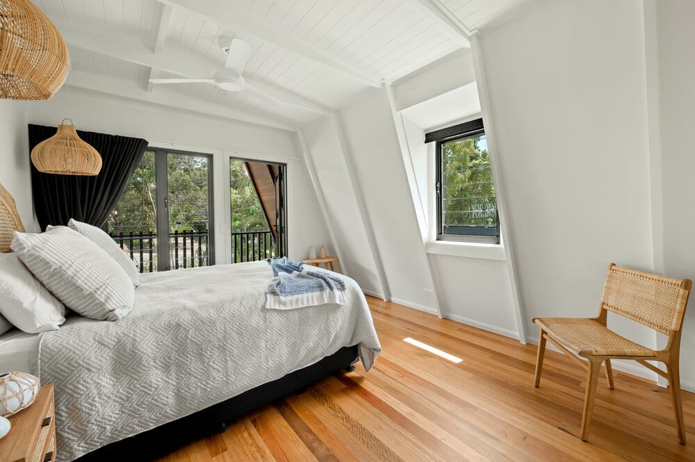 White bedroom with timber floors