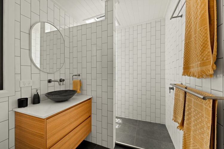 White bathroom with timber vanity counter
