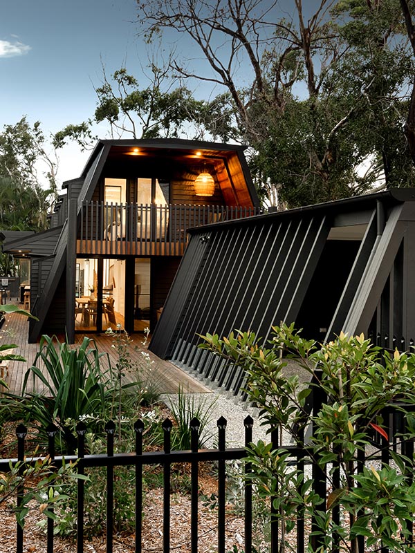 A frame home with greenery and patio