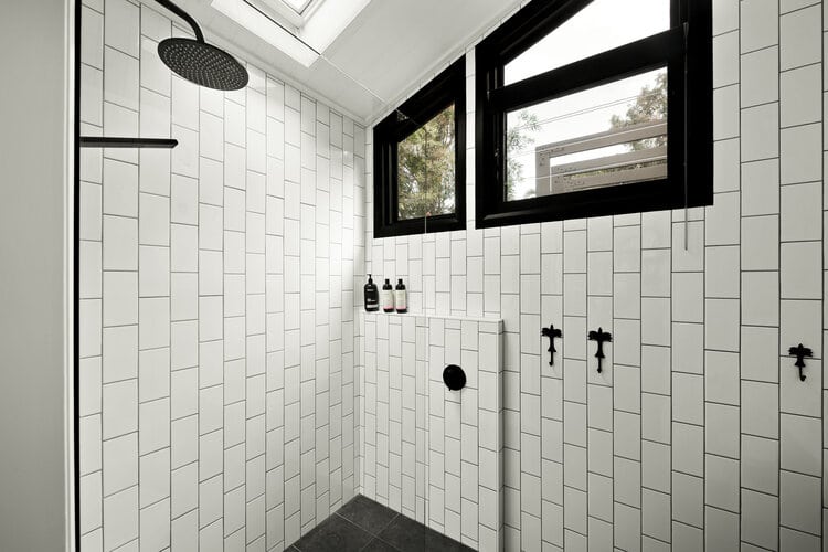 White bathroom with black features and windows