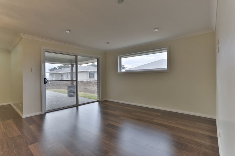 White room with sliding doors and floating timber floors