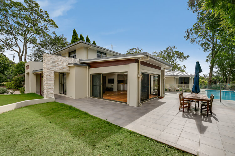 White double storey home and swimming pool