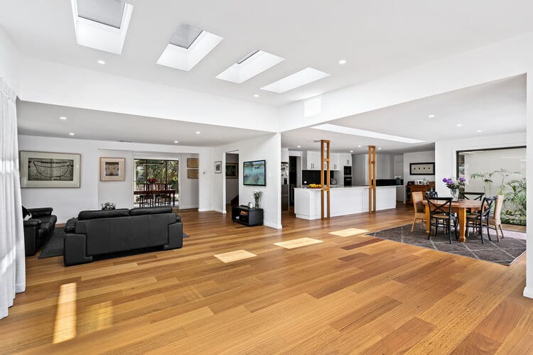 White open plan kitchen, dining, living area and timber floors