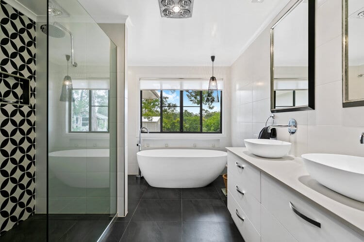 White bathroom with grey feature walls and tiled floors