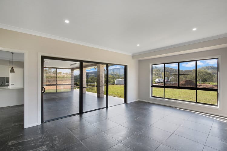 White loungeroom with grey tile floors and sliding doors