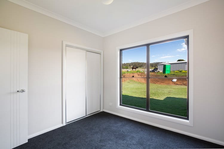 Empty white bedroom with wardrobe