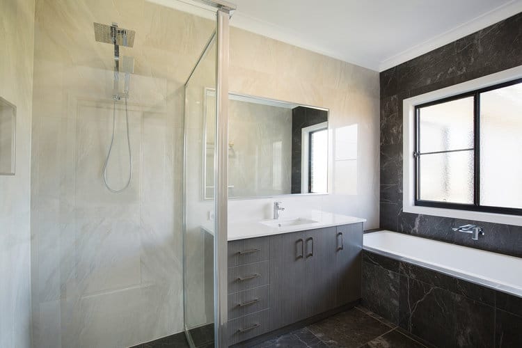 Grey and white bathroom with bath, shower and vanity