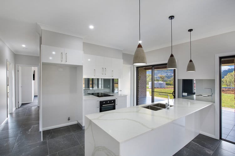 White kitchen with marble laminate benchtops and two pack cupboards