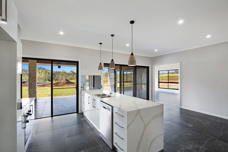 White kitchen walkthrough to sliding door