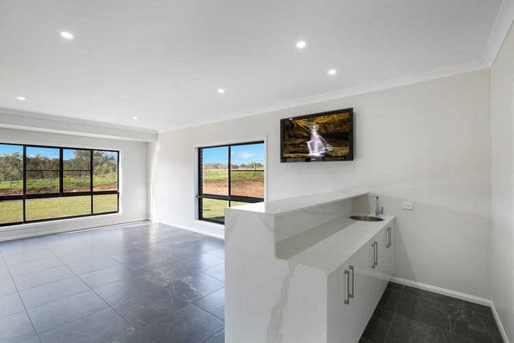 White kitchen with white walls and grey floors