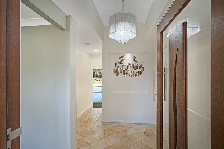Inner entryway with wooden doors and feature wall