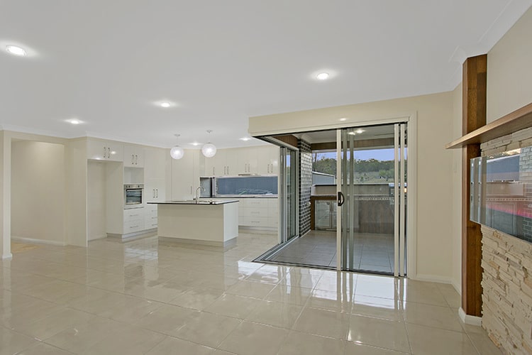 White floors and white kitchen with sliding doors