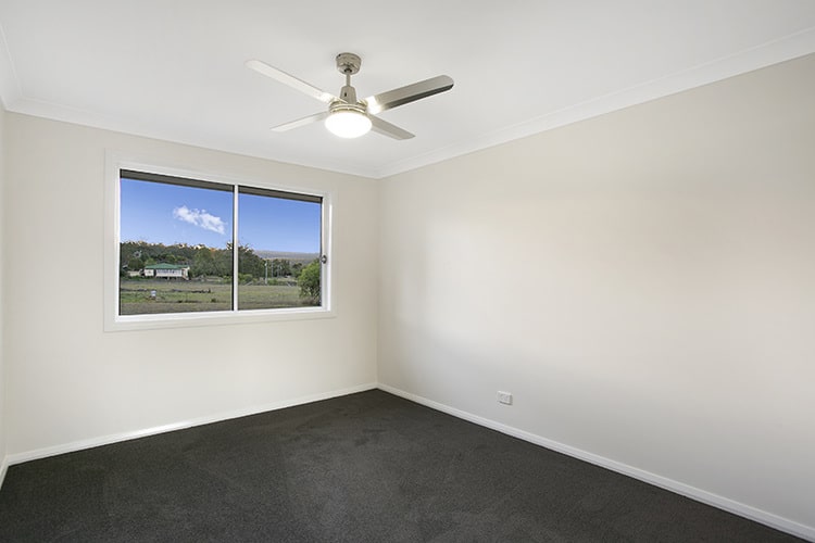 Small room with white walls and grey carpets