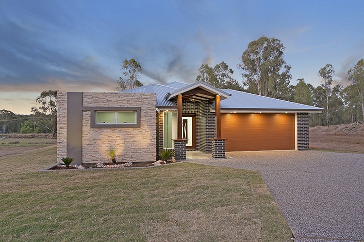 Front view of stone and brick home with brown roller door