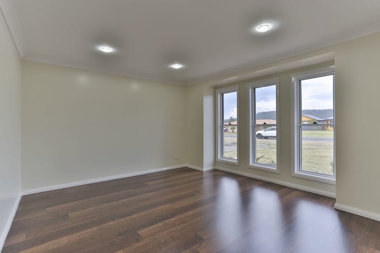 Front entrance room with timber floating floors, overhead lights and front windows