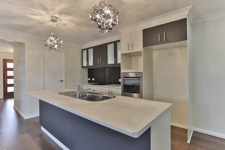 Blue and white kitchen with grey cupboards and white walls