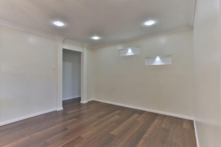 Empty room with floating wooden floors and white walls