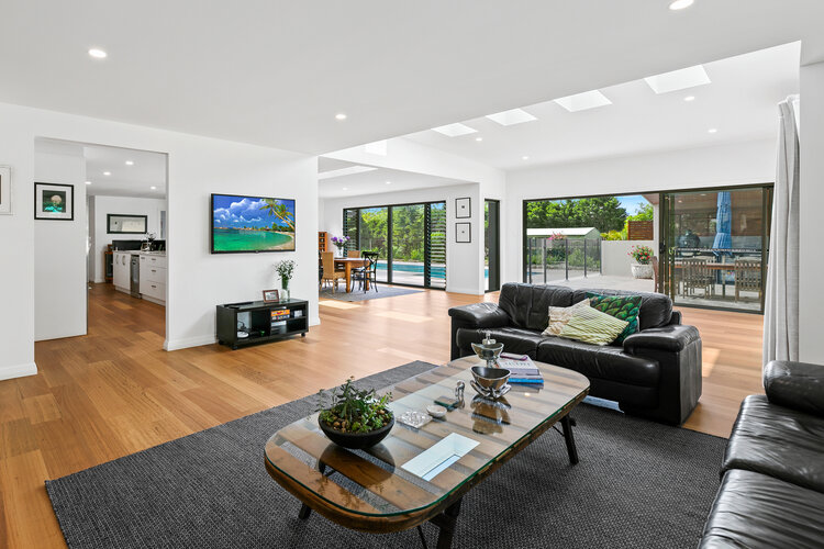 Kitchen, living room, pool and patio setting with wooden floors