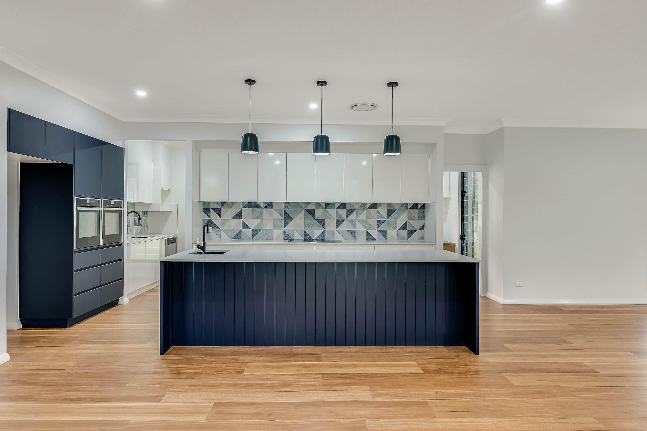 Navy blue kitchen, light fittings and splashback
