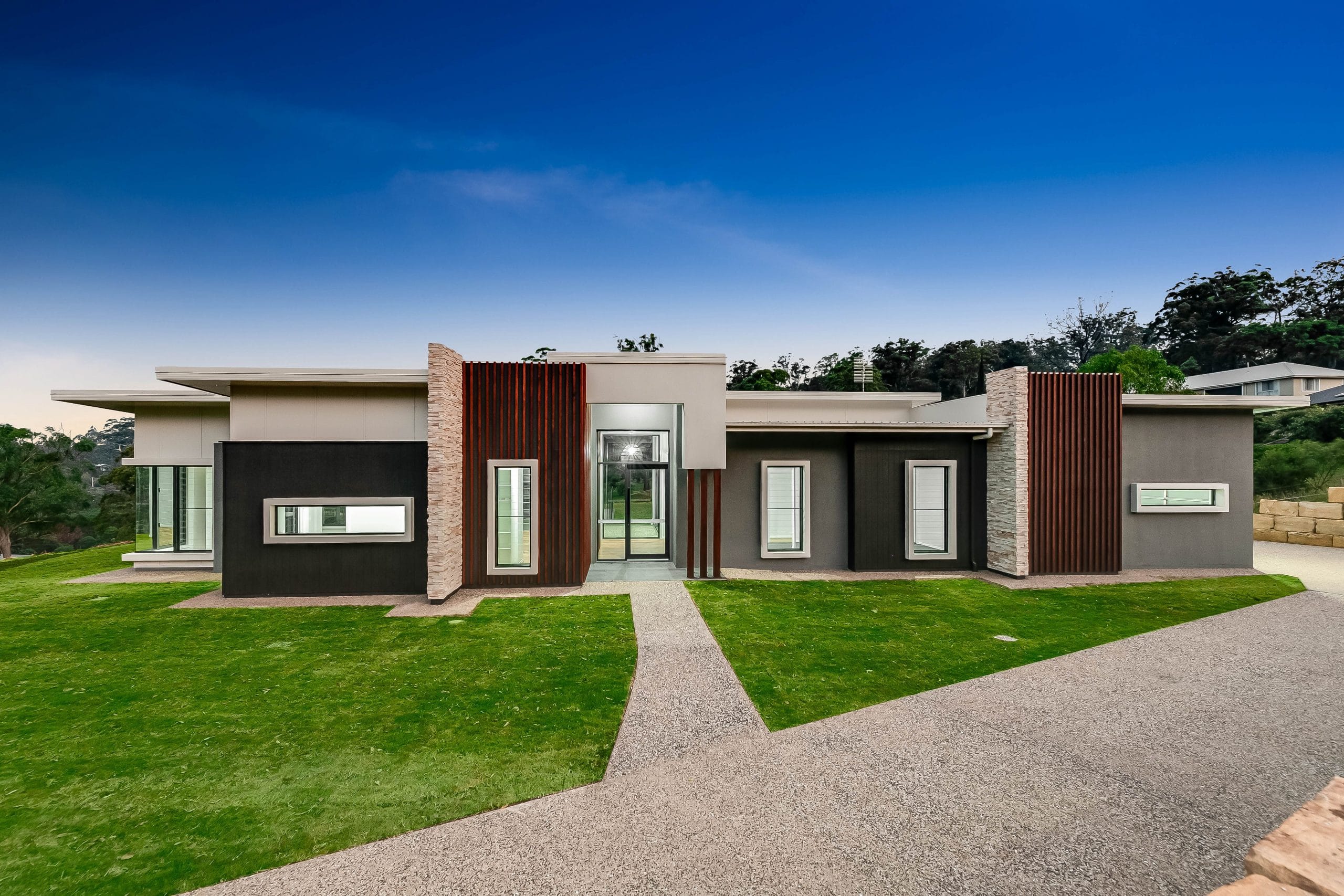 Outdoor view of airy open house with wide black trimmed windows