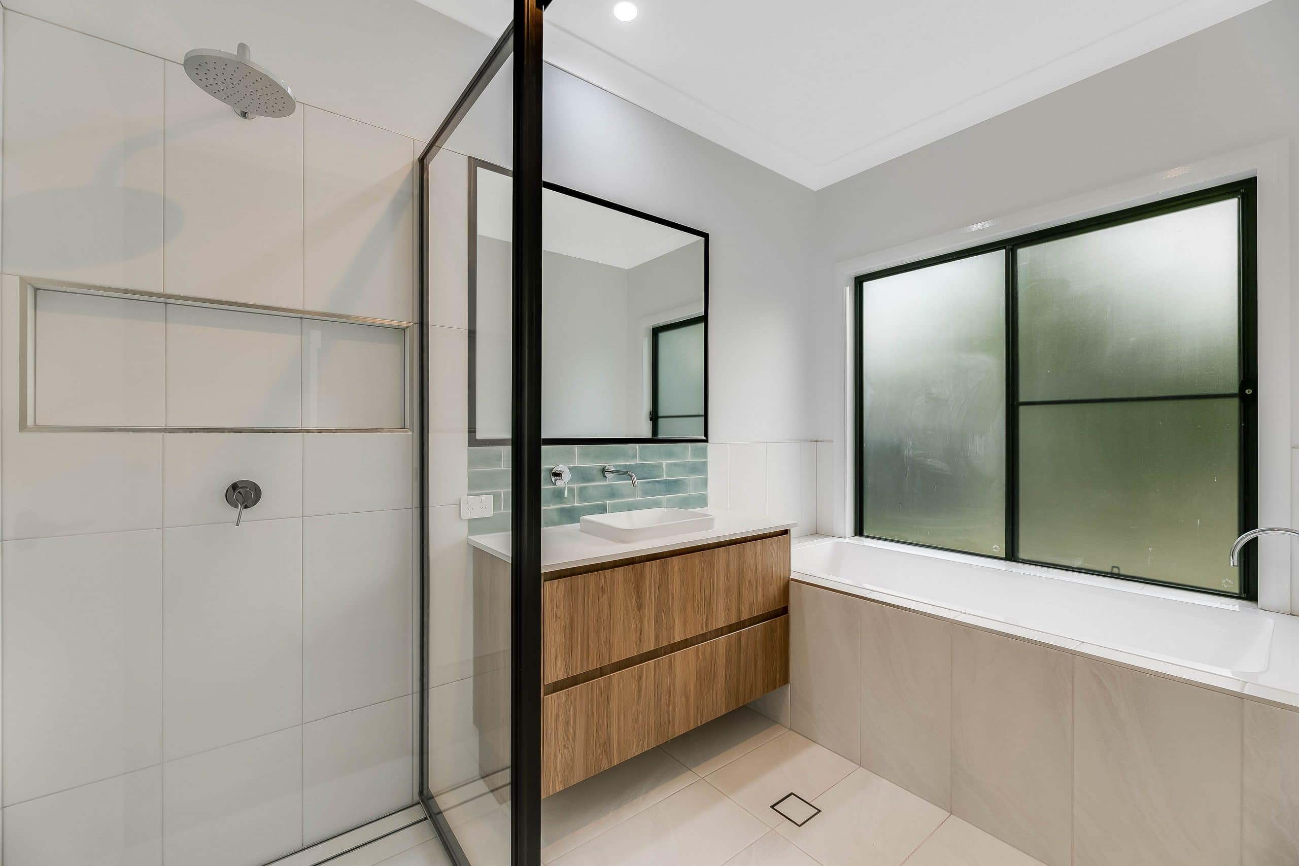 White and black bathroom with bath and shower